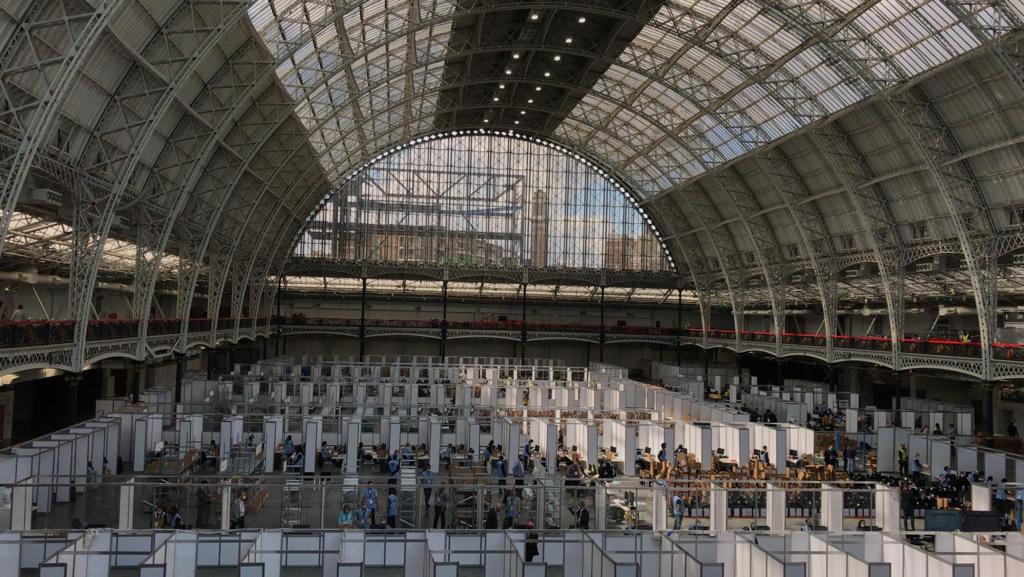 Photo of count at Olympia, London. Huge dome glass roof with counting booths across the large space.