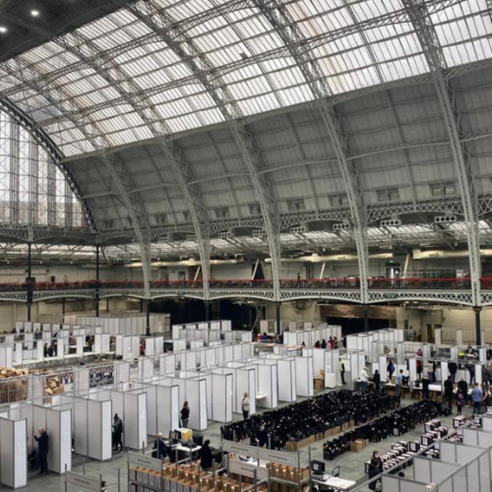 Photo of count at Olympia, London. Huge dome glass roof with counting booths across the large space.