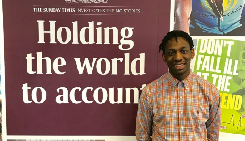 Shingi Mararike standing in front of a Sunday Times banner
