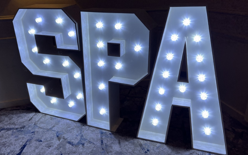 A photo of light up letters S, P and A which stand for Student Publication Association.