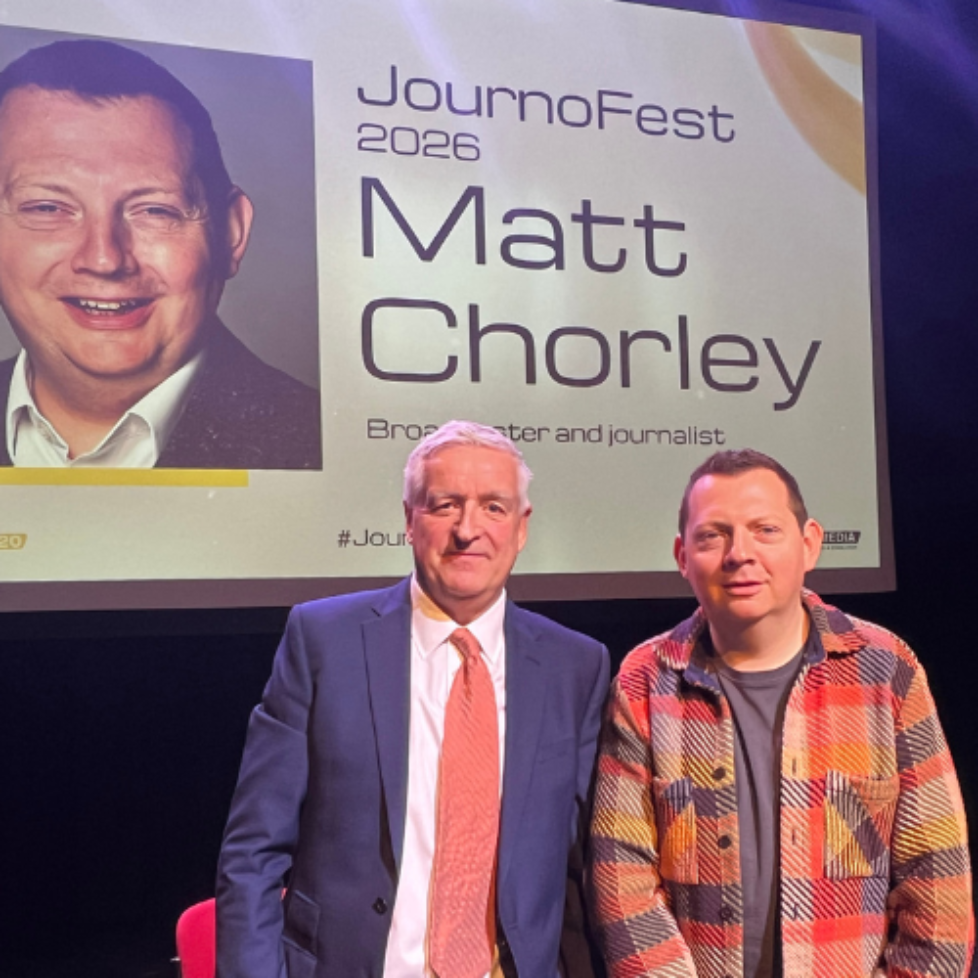 A photo of journalism training consultant Graham Dudman and Broadcaster and journalist Matt Chorley on stage at JournoFest. 2026